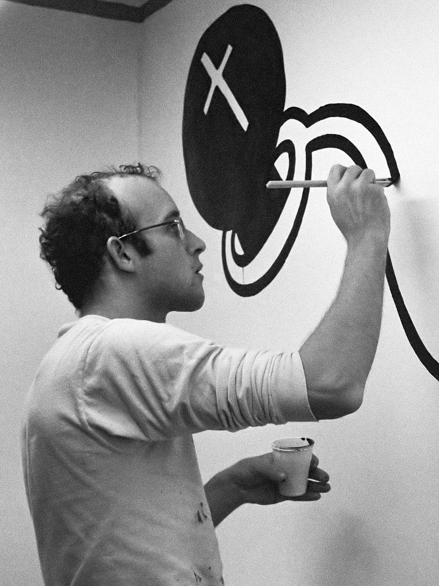 Keith Haring painting on a wall- famous artists