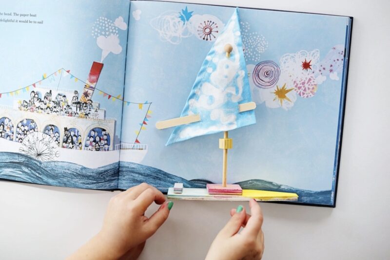 Open picture book and handmade boat art project from KidArtLit- educational subscription boxes