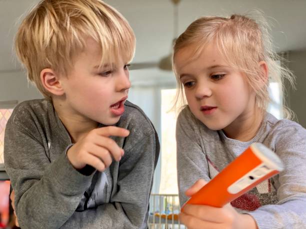 Two preschool children talking to each other, as an example of social-emotional activities