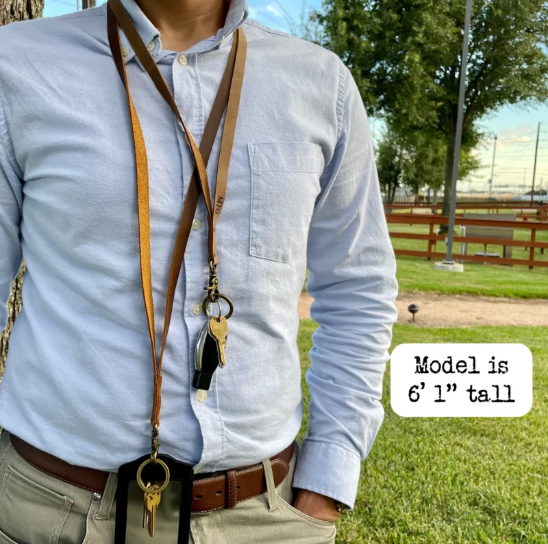 Male teacher standing outside at school wearing leather lanyard.