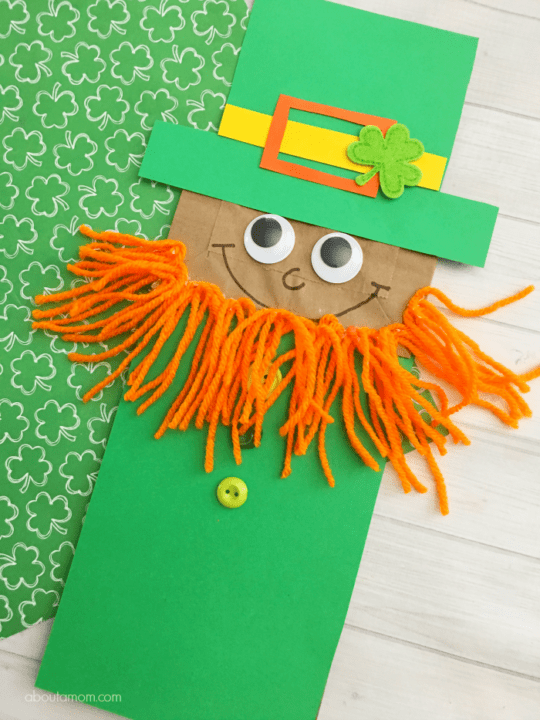 A cute leprechaun puppet is made from a paper bag (St. Patrick's Day crafts for kids)