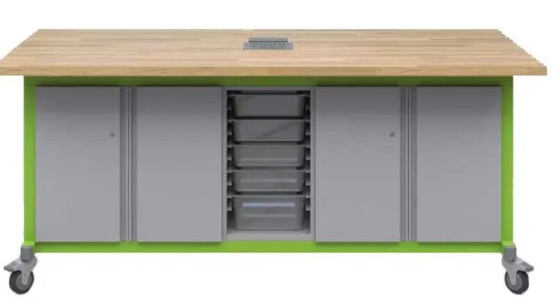 Gray makerspace table with green trim, storage and a butcher block top with power strip
