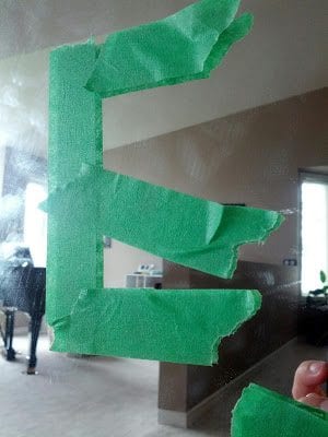 a colorful green letter E taped on a mirror