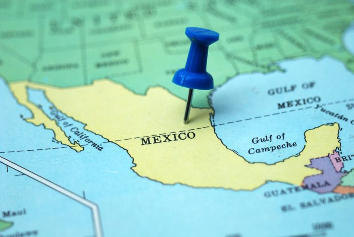 A pushpin marking Mexico as a travel destination on a map
