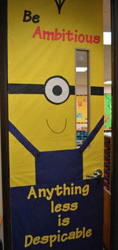 Door decoration of a minion saying "be ambitious, anything less is despicable."