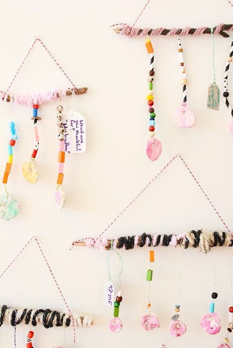 Several mobiles are shown with beads and charms hanging from them including words of gratefulness.
