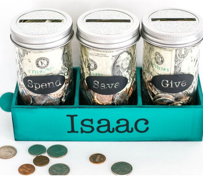 Mason jars turned into spend, save, and give jars, in a wood tray labeled "Isac"