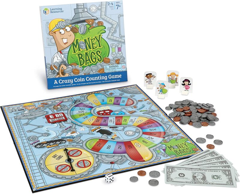 A game box has a bag of money on it and says Money Bags: A Crazy Counting Game. A game board is also shown with a spinner and toy money. (educational board games)