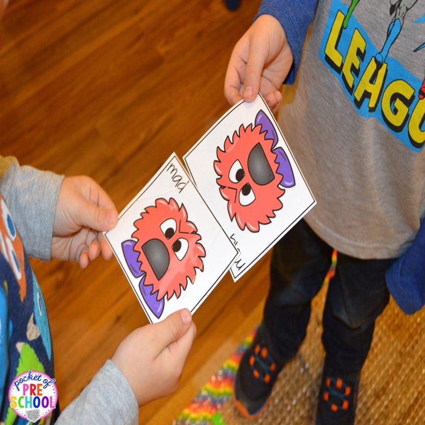 Two children match feeling cards, as an example of social-emotional activities