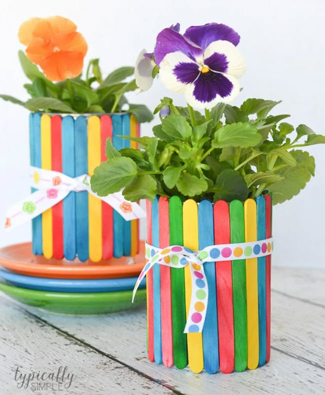 Flower pots made of colorful wood craft sticks and ribbons