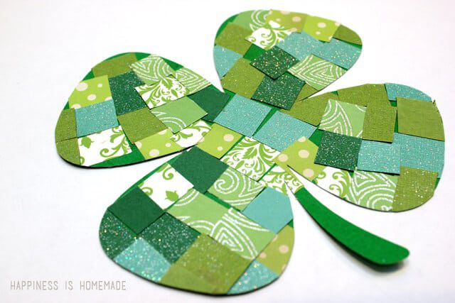 A shamrock is made of small squares of patterned paper, as an example of St. Patrick's Day crafts for kids.