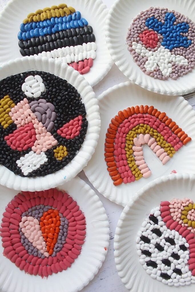 Several mosaics are made from painted beads arranged onto paper plates