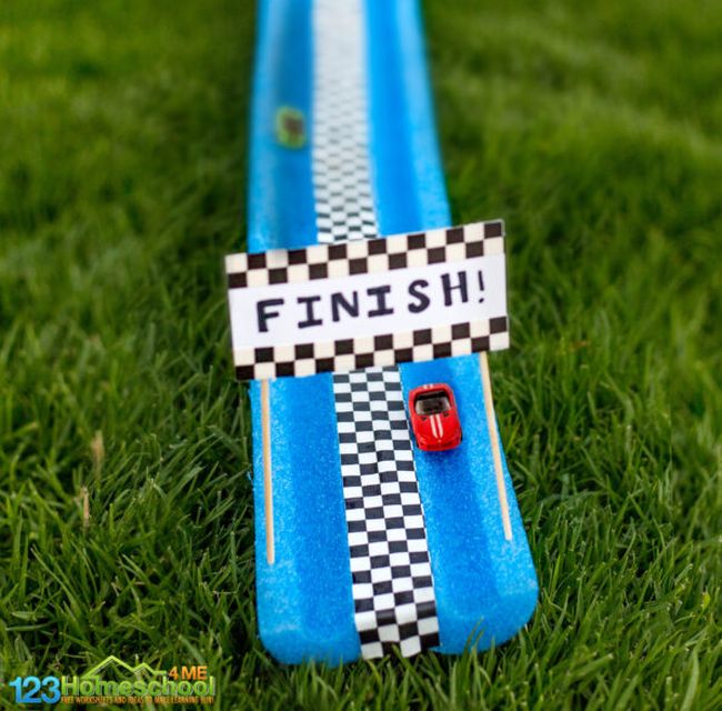 Blue foam pool noodle split in half and taped together side-by-side to create a race track for two matchbox cars (NASCAR Teaching Ideas)