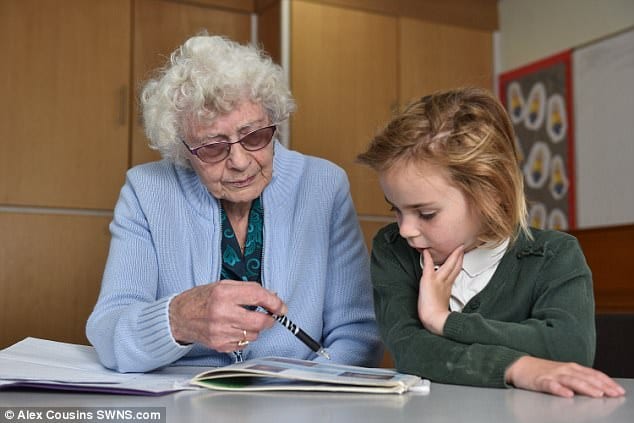 A photo of Britain's oldest teacher with a young student -- teaching a long time