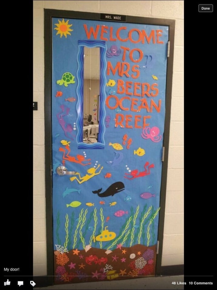 Door decoration of an undersea scene with the words "welcome to Mrs Beer's ocean reef" -- classroom doors