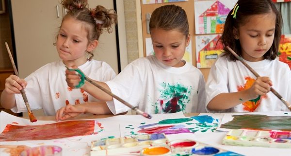 young girls painting in the classroom, as an example of indoor recess ideas