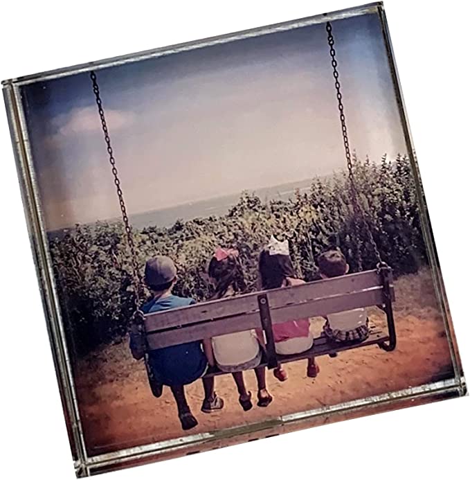 Photo crystal paperweight with children sitting on a swing.