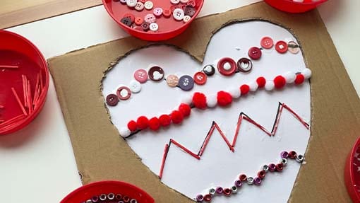 Different shape lines are shown on a heart.  Buttons and beads line the shapes. 