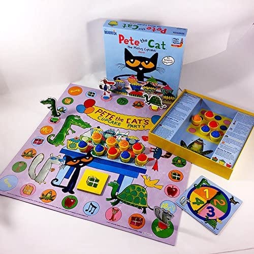 Pete the Cat The Missing Cupcakes game box, board, spinner, and multicolored cupcake game pieces laid out to demonstrate preschool game play