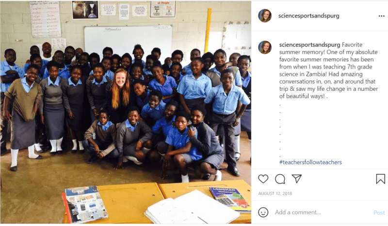Teachers with large group of students in blue shirts in Zambia