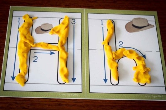 A letter card with yellow playdoh used to fill in the outline