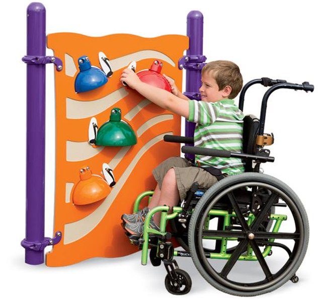 Student in a wheelchair playing with the bells on a vertical panel (playground equipment for schools)