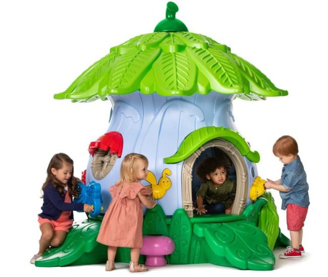 Mushroom shaped play structure with children in and on it