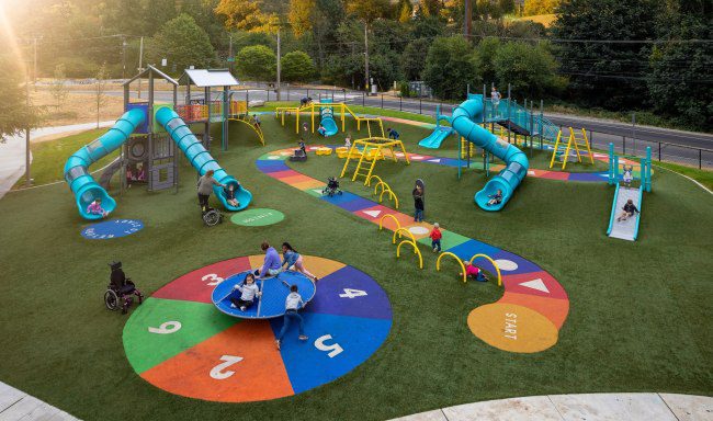 An inclusive playground including a sensory path, slides, and other playground equipment for schools