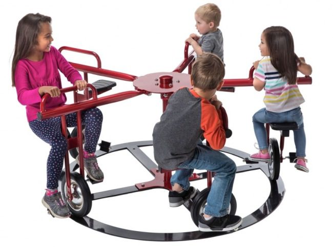 Students riding bicycle seats mounted on a circular track