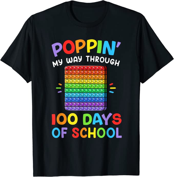 A black shirt has a pop it fidget toy in rainbow colors. It says Poppin My Way Through 100 Days of School also in rainbow. (100th day of school shirt ideas)