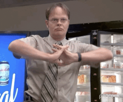 GIF of Dwight Schrute from The Office stretching