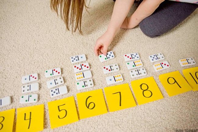 Toddler lining up dominos by number (Preschool Math Games)