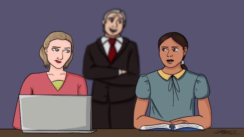 Principal blurred out behind two teachers working