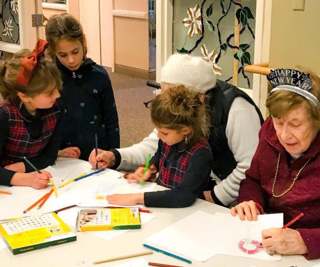 Children and senior citizens working on an art project together (Project Based Learning Ideas)