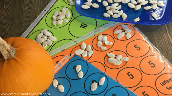 a pumpkin seed counting activity for young learners including colorful number mats, pumpkin seeds and a small pumpkin