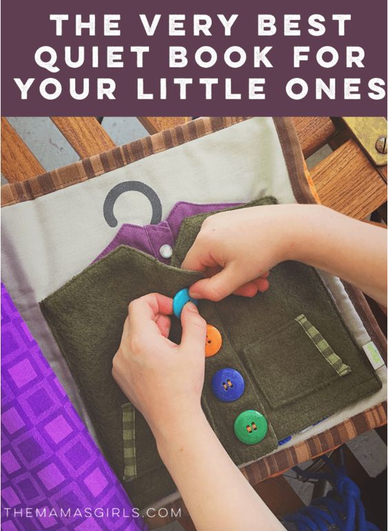 A child's hands are shown buttoning buttons on the pages of a soft book. (fine motor activities)