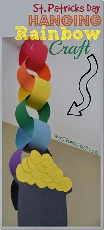 Different color construction paper are cut into strips and looped together to form a chain. A pot of gold is at the bottom.