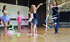 teacher and students doing ribbon dancing, as an example of indoor recess ideas