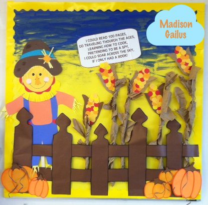 October bulletin board ideas include this one with a scarecrow behind a fence with pumpkins and corn stalks. Text shows lyrics to 