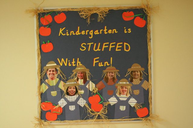 An example of September bulletin board ideas says "Kindergarten is STUFFED with fun." It shows 6 scarecrows made of construction paper with actual photos for faces of the teachers.
