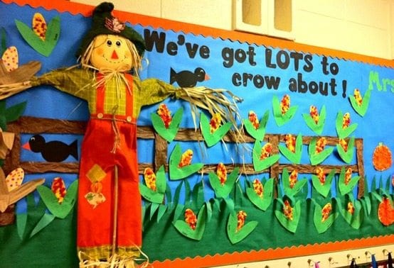 A 3-D scarecrow is surrounded by corn stalks and there are a few crows. The text reads, 