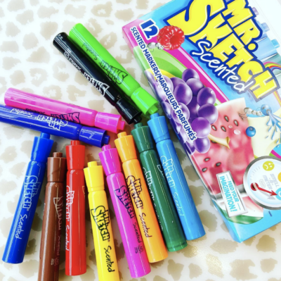 Scented markers scattered on table