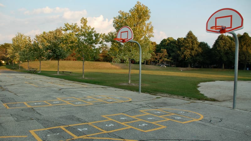 A playground with basketball courts on a school campus
