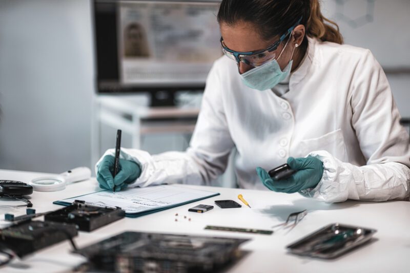 Forensics. Police Expert Examining Confiscated Mobile phone