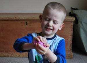 A child wads up a piece of paper