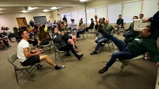 Students playing baseball while seated