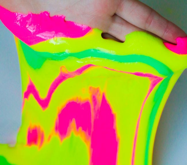 Student playing with neon colored slime (Second Grade Science)