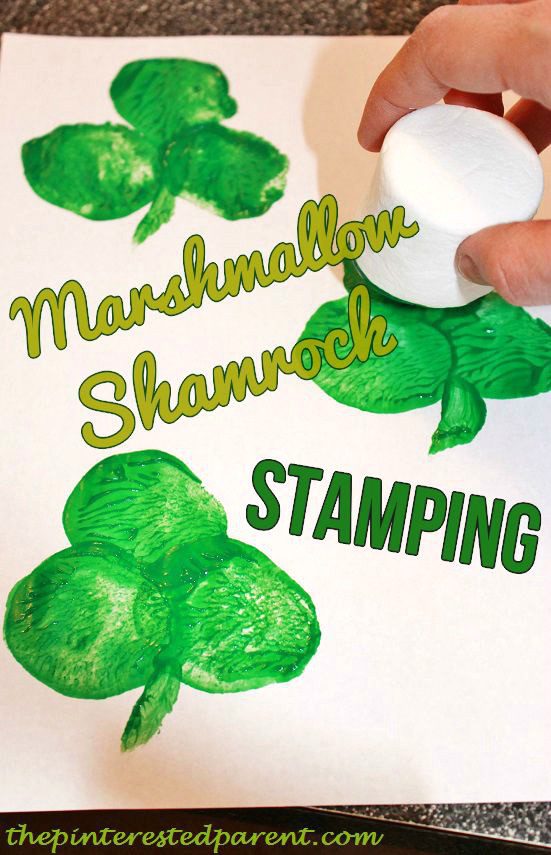 A shamrock is created on a page using a large white marshmallow as a stamp dipped in green paint (St. Patrick's Day crafts for kids)