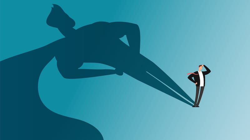 Businessman with superhero shadow. Ambition and business success vector concept