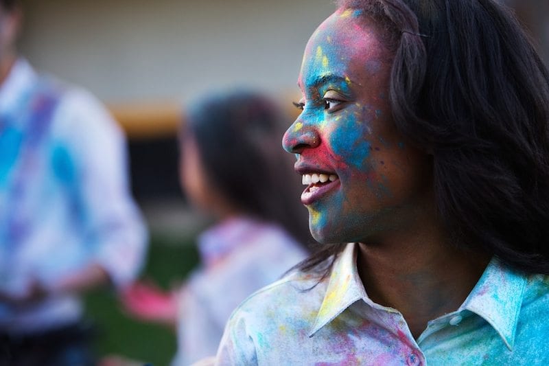 young African American girl with colorful paint on her face - motivating students
